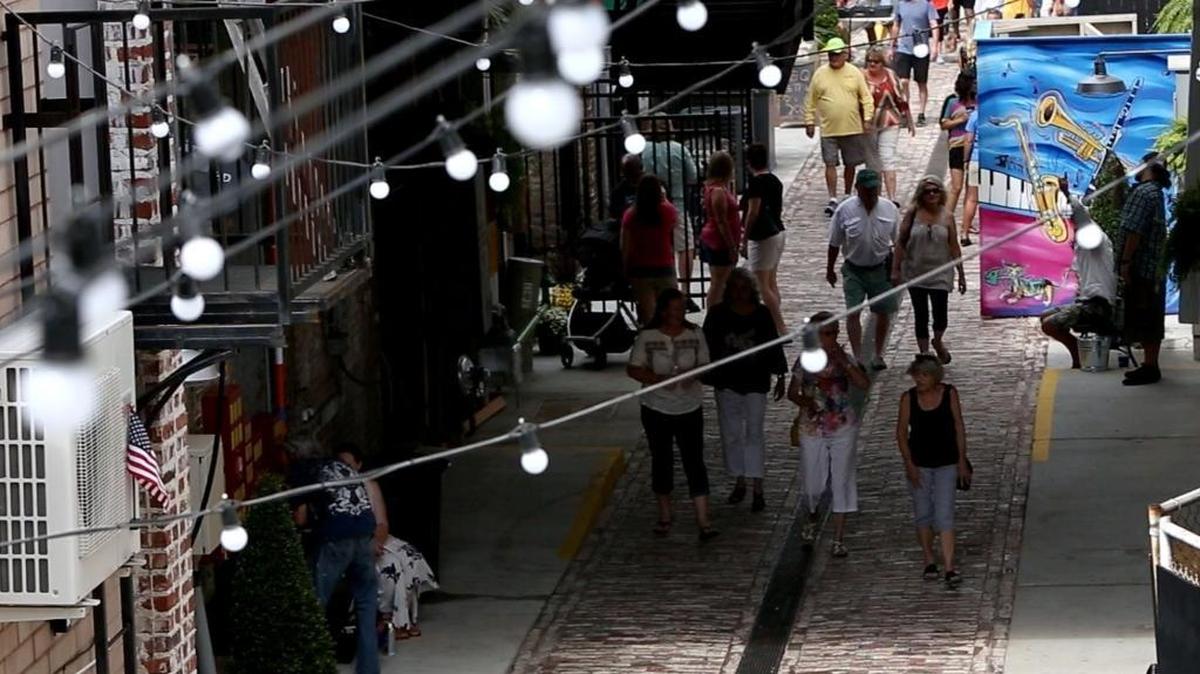 Visitors walk through Fishbone Alley in downtown Gulfport during Gulfport's View The Cruise on the first day of Cruisin' The Coast on Sunday, Oct. 2, 2016.