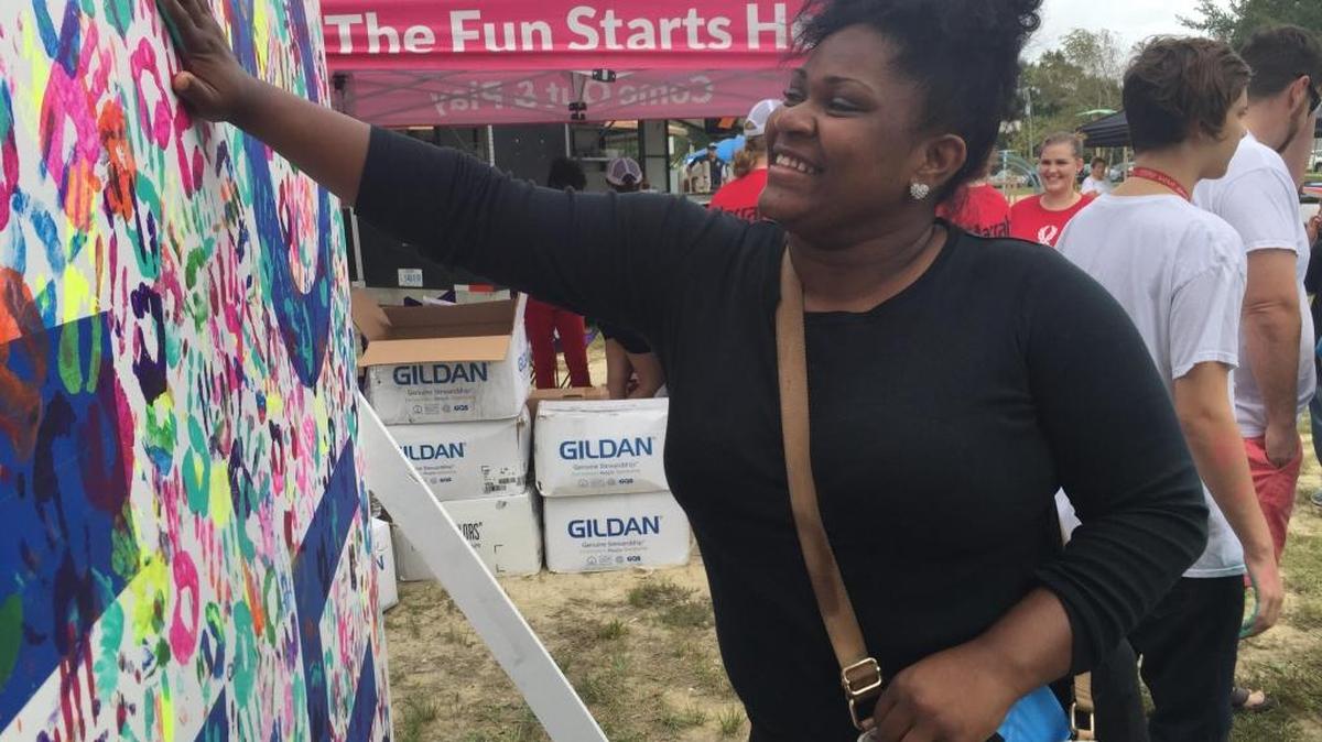 Tyreonia Hopper of Gulfport places here hand on the ‘love wall’ at the MS Gulf Coast Equality Fest on Saturday, Oct. 21, 2017.