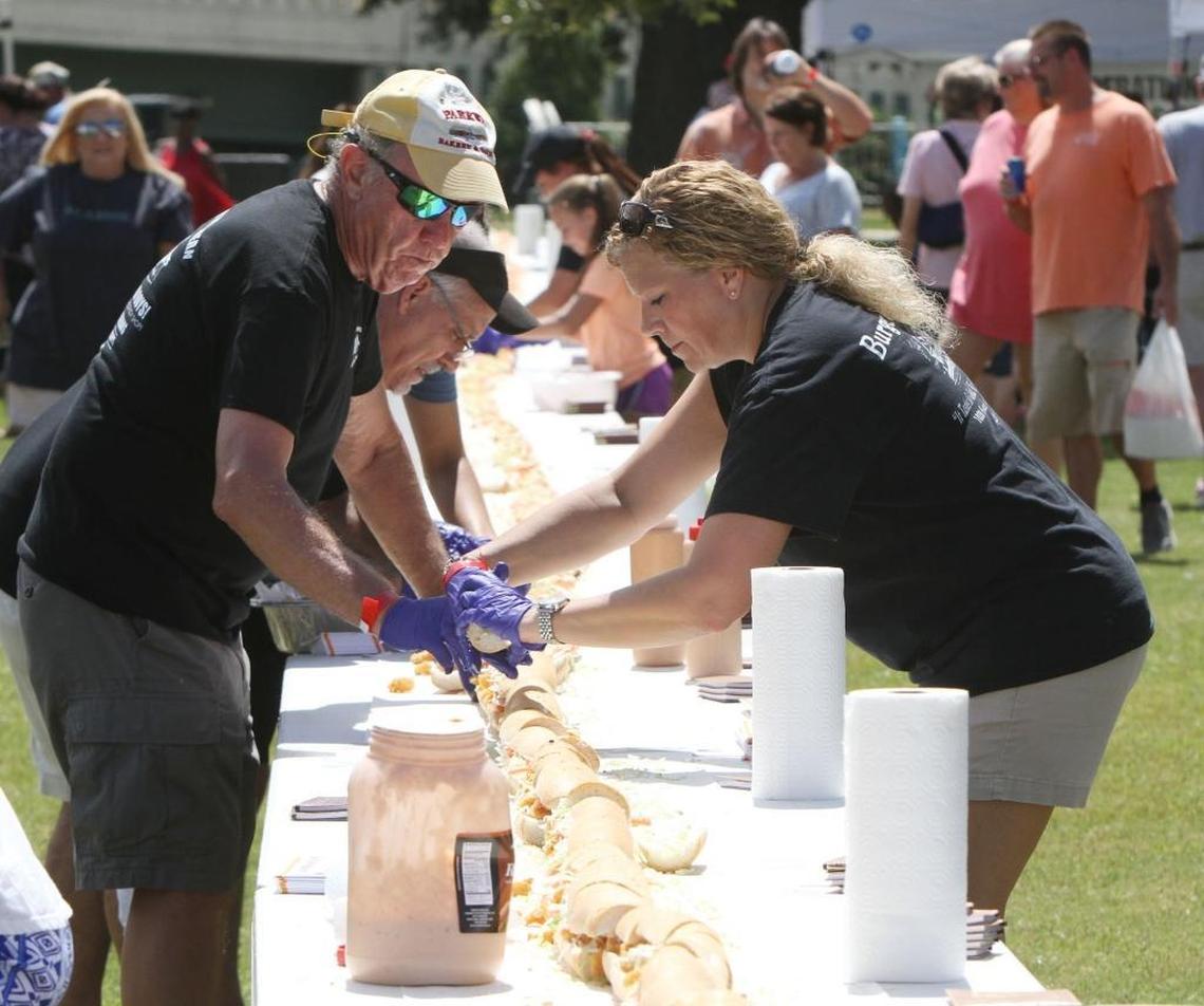 Volunteers work to build a 200-foot po-boy at the Biloxi Seafood Festival in 2016. They’ll be building another one on Saturday.