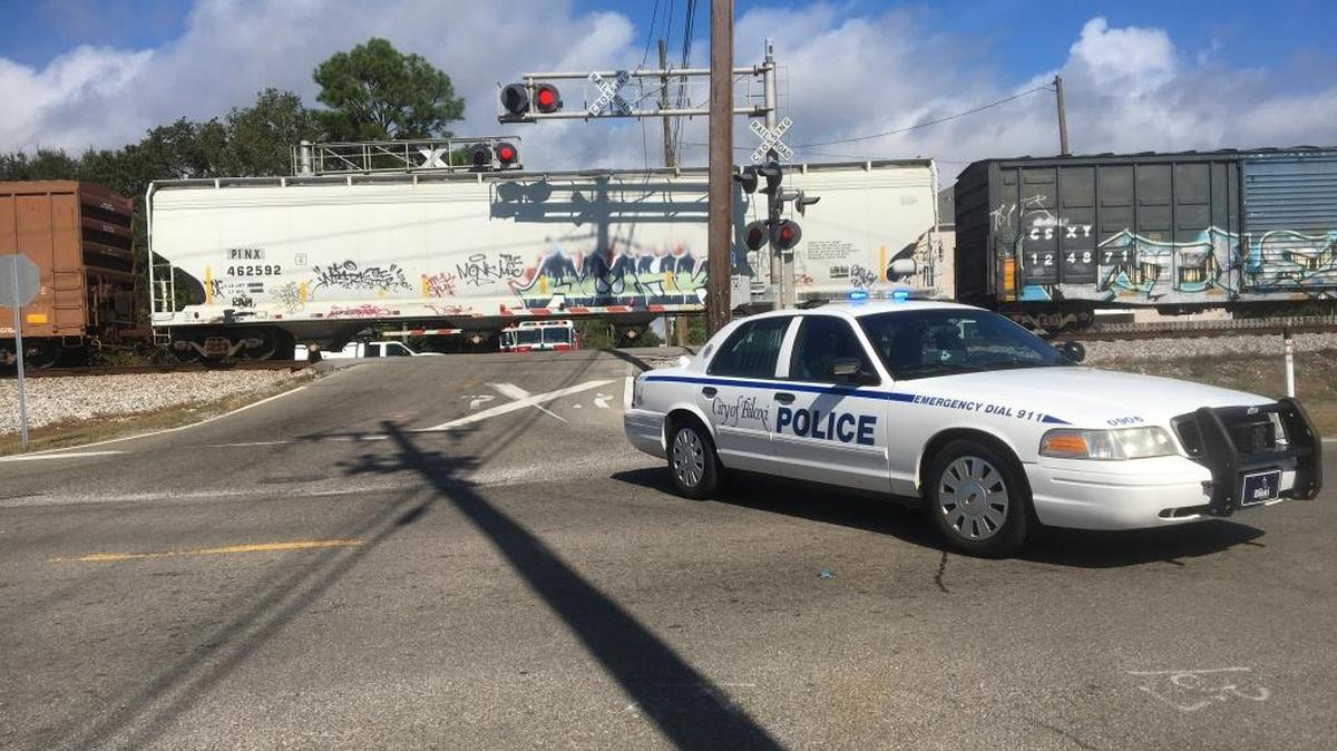 A Biloxi police car blocks Irish Hill Drive at McDonnell Avenue after a pedestrian was struck by a train Sunday morning.