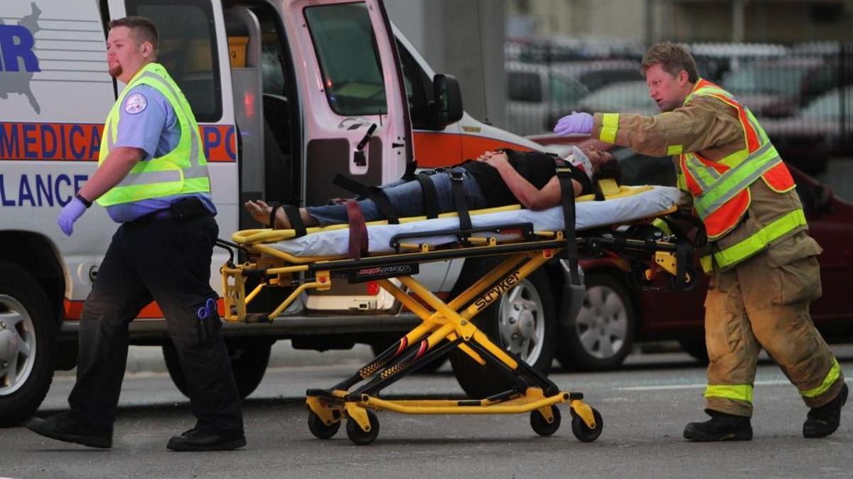 Emergency responders from American Medical Response transfer a patient to an awaiting ambulance at the scene of a fatal accident on U.S. 90. AMR and companies it absorbed have provided ambulance service in Harrison County since 1974, a company officer says.
