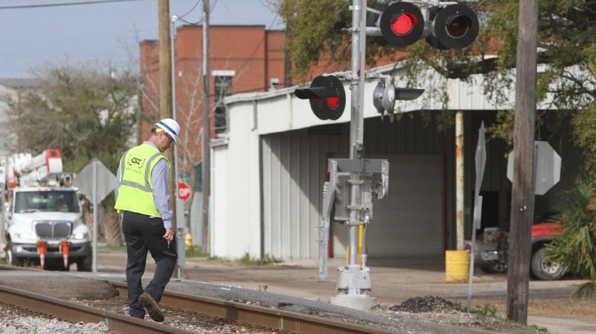 A CSX investigator walks the tracks on Wednesday, March 8, 2017 at the scene of Tuesday’s fatal train-bus wreck at the Main Street railroad crossing in Biloxi. CSX inspectors will be back in Biloxi next week for a diagnostic review of Biloxi’s railroad corridor.