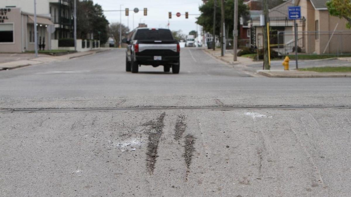Scars in the asphalt from vehicles crossing the railroad tracks at the Main Street railroad crossing can be seen on the north side of the tracks on March 8.