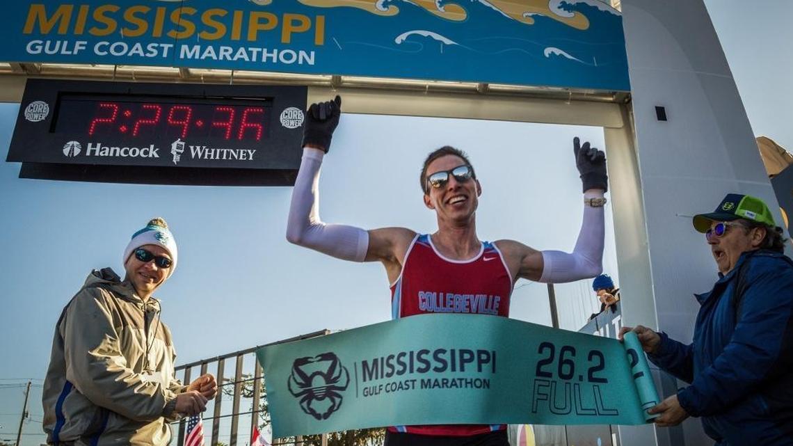 Dan Schneider of Minneapolis crosses the finish line of the Mississippi Gulf Coast Marathon in Biloxi on Dec. 10, 2017.