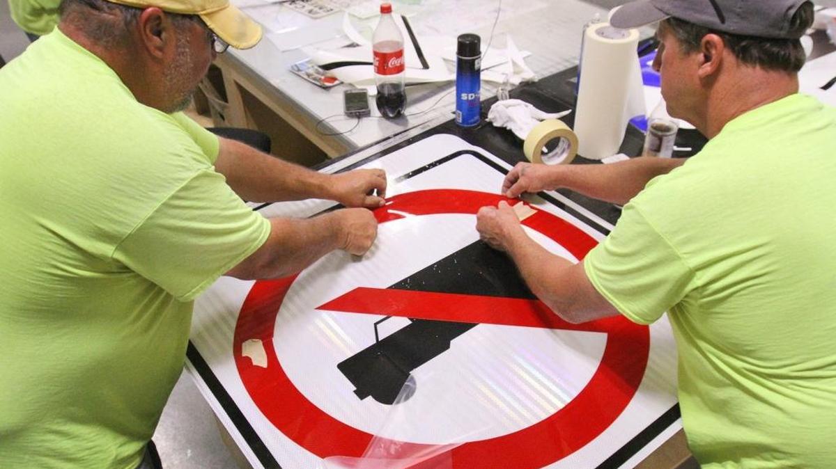 Biloxi public works employees Frank Lassere, left, and George Juanico make ‘no truck’ signs Friday, March 10, 2017, to put up at the Main Street railroad crossing in response to the train-bus wreck Tuesday and another bus trying to cross the tracks Friday.