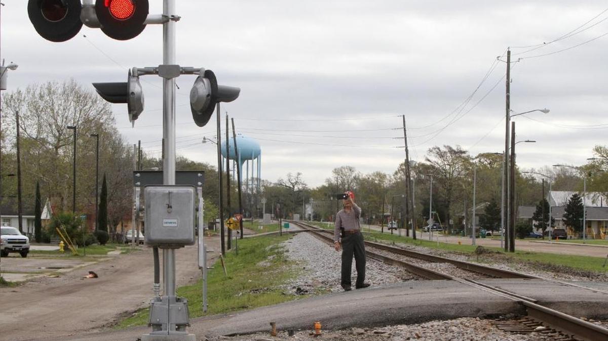 Phuoc Tran of Biloxi takes photos on Wednesday, March 8, 2017 at the scene of Tuesday's fatal train-bus wreck at the Main Street railroad crossing in Biloxi. Four people died, eight were critically injured and a total of 44 were taken to five area hospitals.
