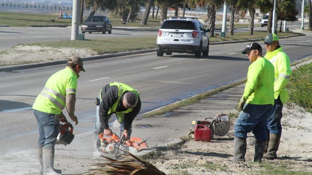 Biloxi workers cut into a sidewalk on U.S. 90 so they can make repairs to a broken force main that sent sewage gushing onto the highway Thursday morning in the central beach area.