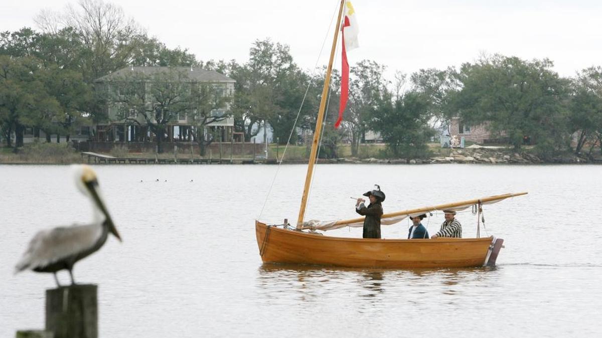 Andrew Alexander, right, drives the boat carrying R. J. Deno, left, as Pierre Lemoyne d’Iberville and David Harder as Jean-Baptiste Bienville during a 2009 recreation at Fountain Pier in D’Iberville of the explorers’ 1699 landing in South Mississippi. This year’s reenactment in D’Iberville on March 25 will be part of Mississippi’s bicentennial celebration.