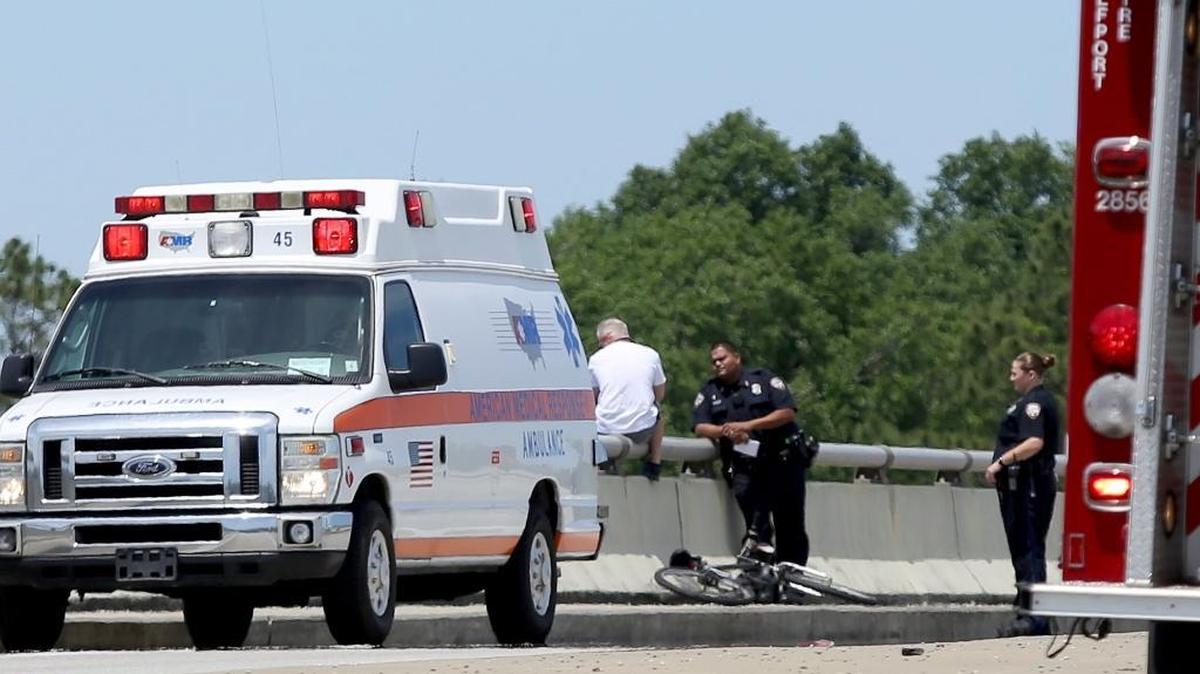 Gulfport Police Officer Luis Garcia talks to a man who threatened to jump off the top of Kremer Bridge on Cowan-Lorraine Road on Wednesday, April 22, 2015. The man had wrapped what appeared to be a cable around his neck, but police negotiators were able to talk him down and he left the scene by ambulance.