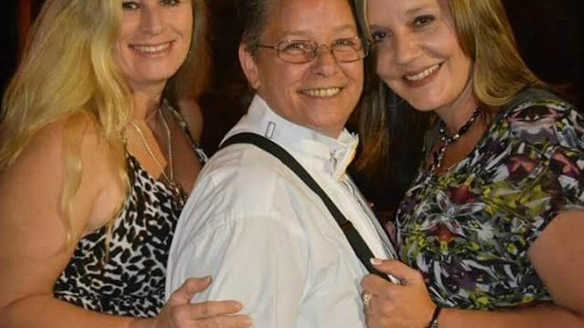 Lynn Koval, center, has operated an LGBT bar in Biloxi for almost 21 years. Koval is pictured with twin sister Lysa Broussard, left, manager of Just Us Lounge, and wife Tammy, who also helps run the bar.