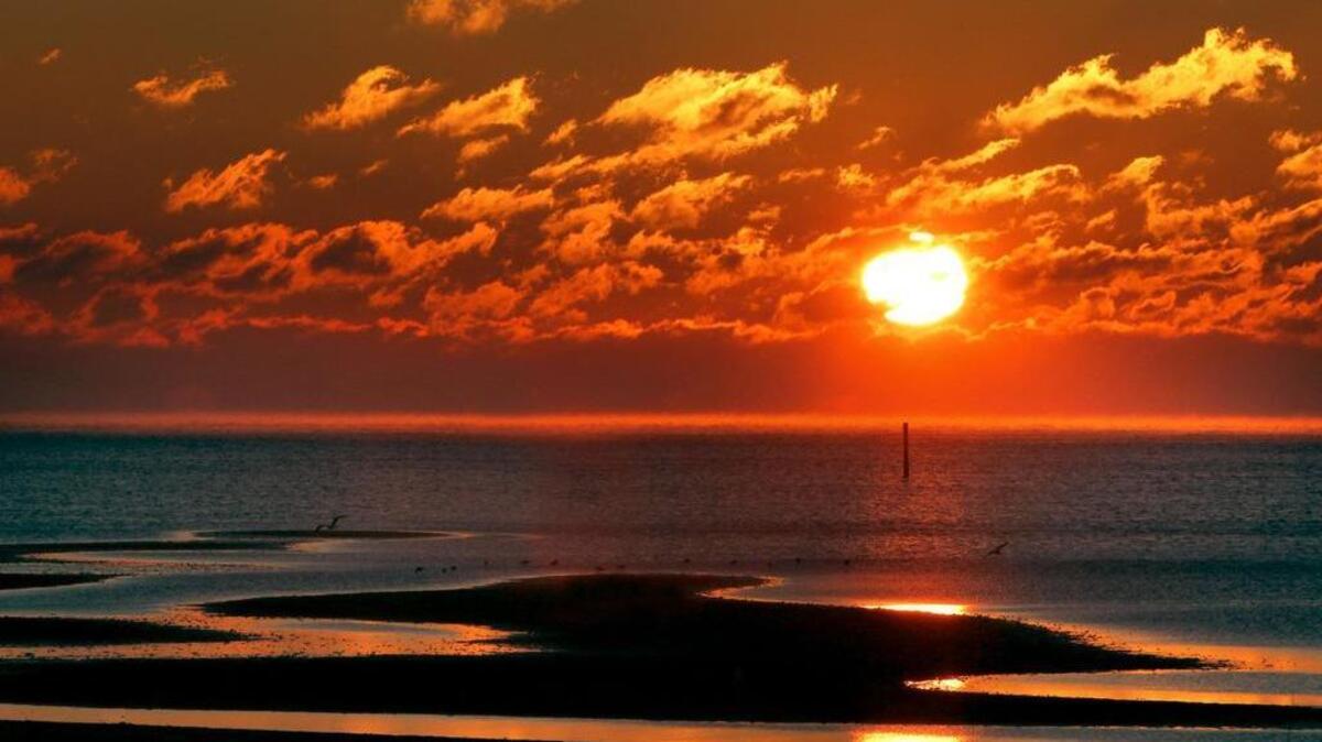 The sun rises over the beach in Gulfport. Smart Assets named Gulfport the most affordable beach town in the U.S. for the second year in a row.