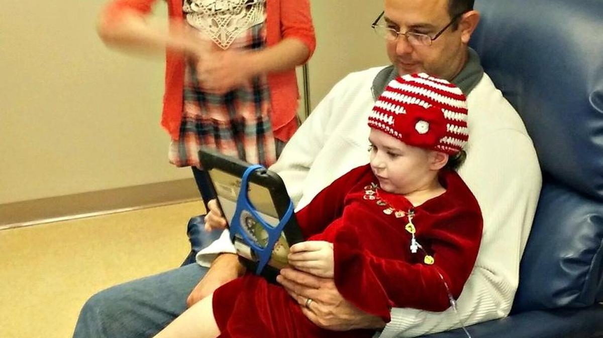 Harrison County Sheriff's Sgt. Zach McCabe spends time with daughter Lily, 7, as she undergoes treatment after having a brain tumor removed at Ochsner Medical Center. Lily’s sister Ava, 8, also is pictured.