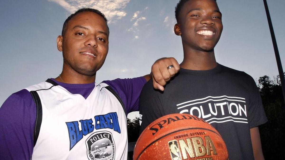 Tony Alves, left, and Josh Simmons team up to promote the Blue Crew vs. Solution basketball game that will be played Monday, Dec. 5, 2016, as a community outreach.
