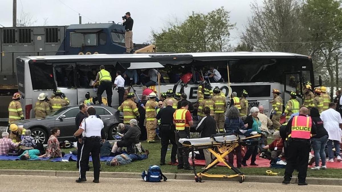 Rescue personnel work to remove passengers from a charter bus that was hit by a CSX train at the Main Street crossing in Biloxi, Miss. on Tuesday, March 7, 2017.