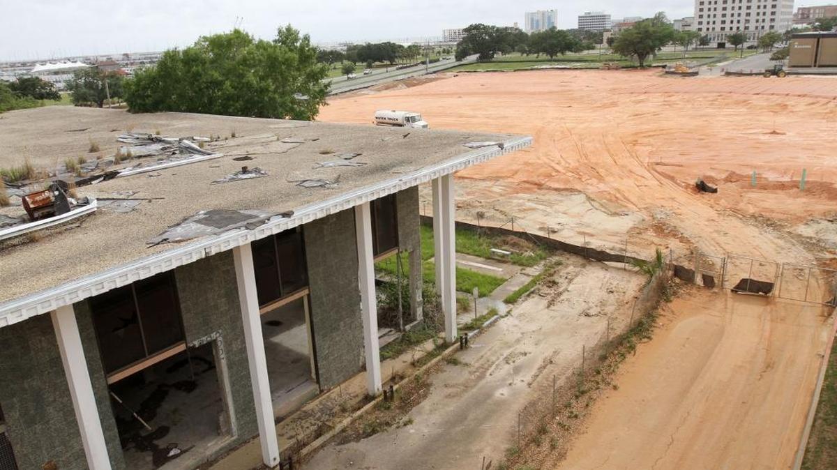 Progress on the Mississippi Aquarium site in downtown Gulfport can be viewed online. The former Gulfport library building, left, will become a Coast Transit Authority transit station with the aquarium offices on the second floor.