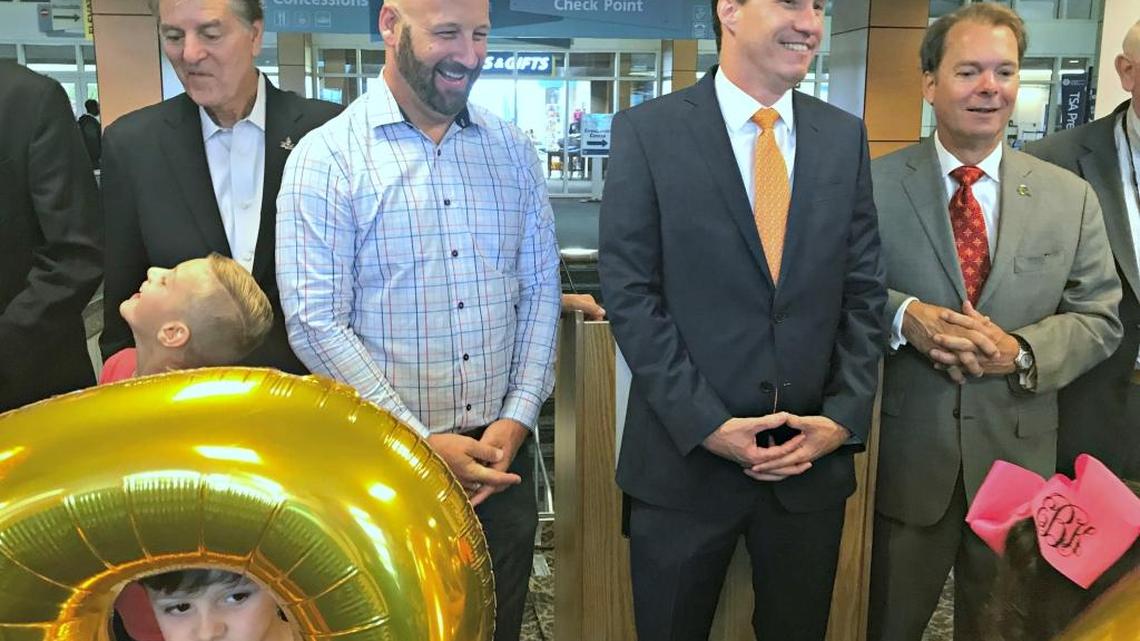 From left to right, Biloxi Mayor Andrew 'Fofo' Gilich, Daniel Meier of Allegiant airline, Clay Williams of Gulfport-Biloxi International Airport and Gulfport Mayor Billy Hewes are joined by balloon-carrying children on hand Tuesday morning to welcome Allegiant back to the airport. Allegiant will be offering flights twice weekly between Gulfport and Orlando.