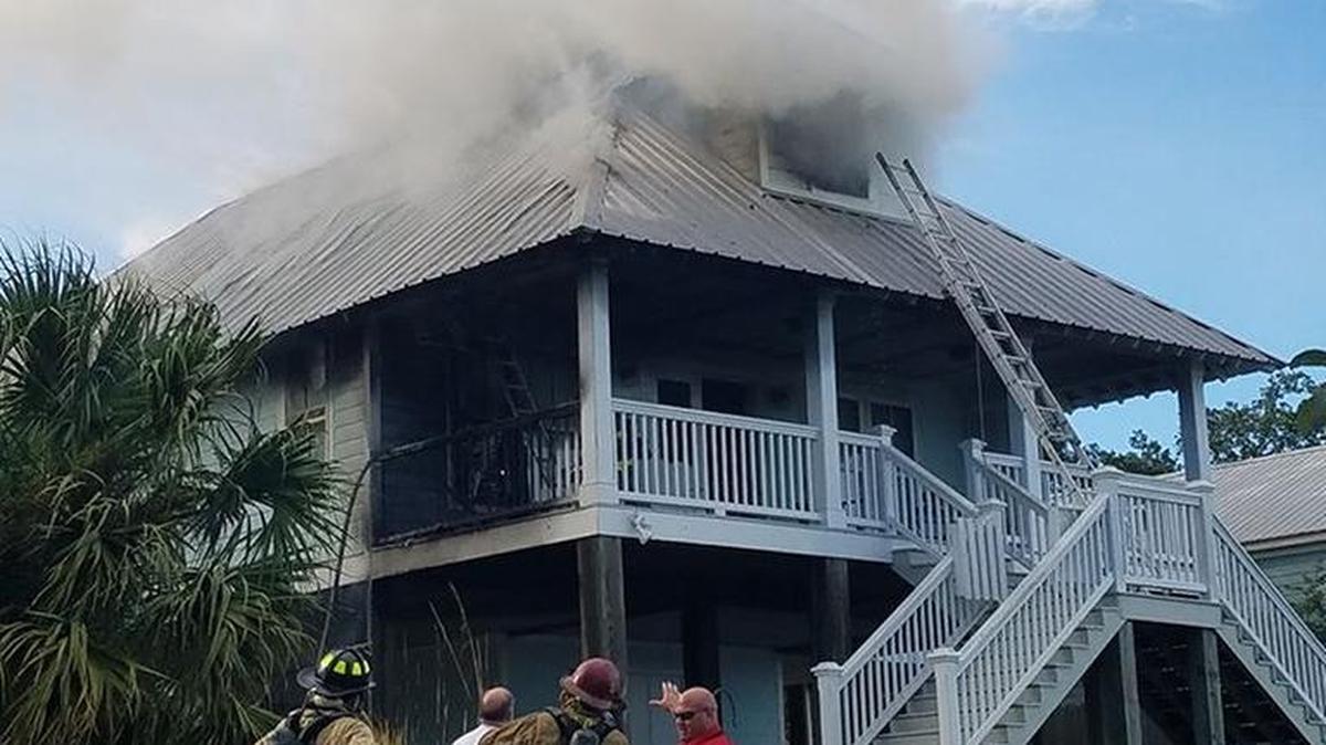 Biloxi firefighters battle a blaze on Back Bay, Sunday, Oct. 9, 2016.