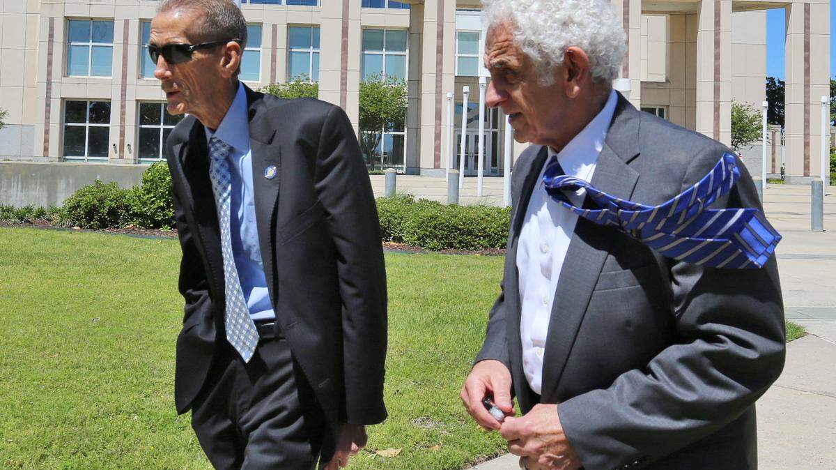 Harrison County Coroner Gary Hargrove, left, leaves the federal courthouse in Gulfport on Monday, April 16, 2018, with attorney Joe Sam Owen, who is defending him against charges that he discriminates by giving white-owned funeral homes most of the county's business. Hargrove and the county maintain he selects funeral homes in few cases and is fair when he does.