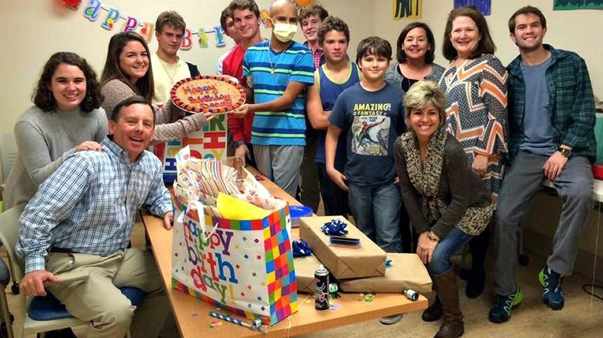 Donny Faerber's supporters helped him celebrate his 15th birthday in January, after he started chemotherapy for leukemia. Terry Robinson, far left, Jennifer Myers, front in boots, Virginia Robinson, behind, Myers, and Nick Myers, far right, have played major roles in Faerber’s life. Jennifer and Nick Myers shared Nick’s own experience with leukemia, while the Robinsons have become a surrogate family for Donny. Katherine Robinson is pictured behind her father, while Emily Robinson helps Donny, in mask, hold his cake.