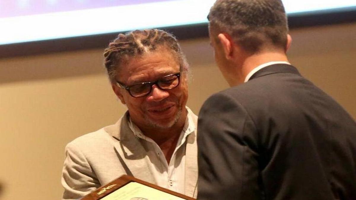 District Attorney Joel Smith presents Coast broadcaster Rip Daniels with the Crime Victims Community Service Award on Friday at a program in observation of National Crime Victims Rights Week.
