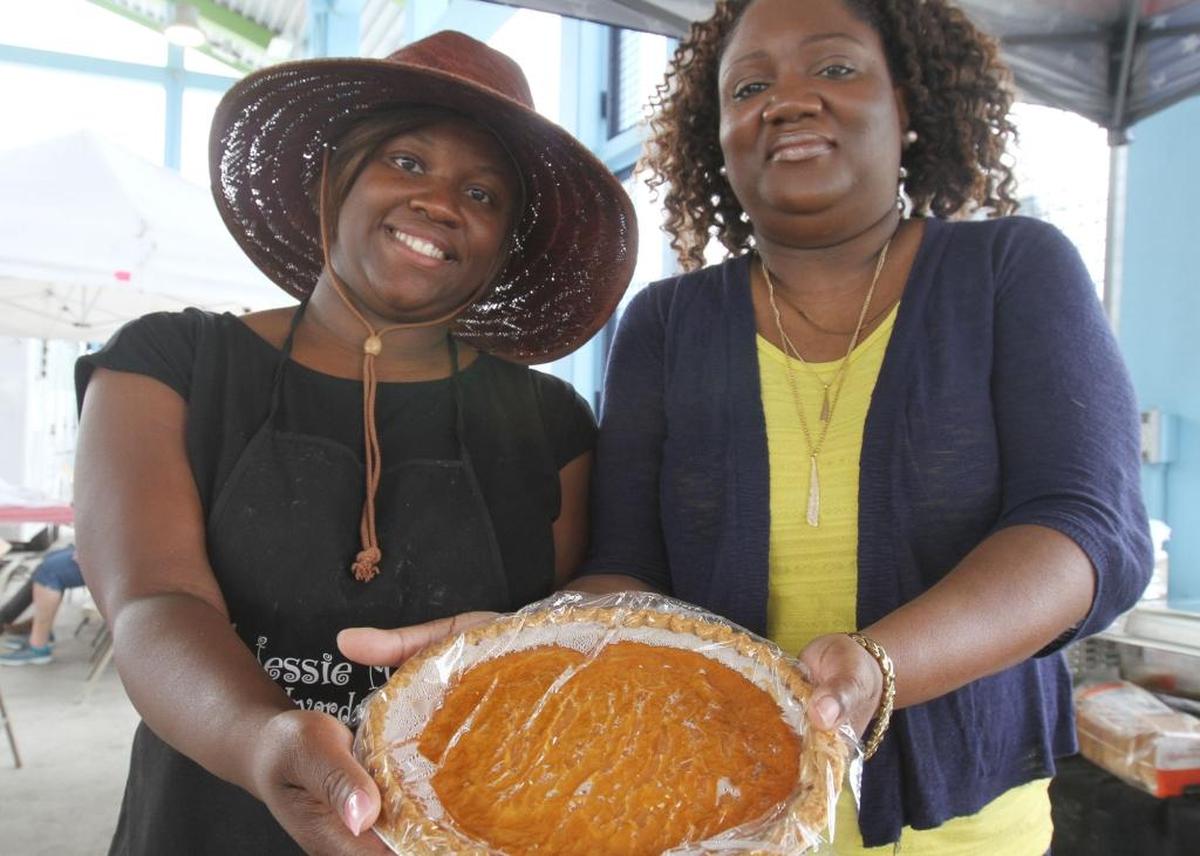 Zarnika Fikes, left, and Ulanda Keyes of Jessie Mae's Backyard Cooking show off one of their pumpkin pies at the Biloxi Blessing of the Fleet Fais Do-Do at Point Cadet Plaza on Saturday, June 3, 2017.