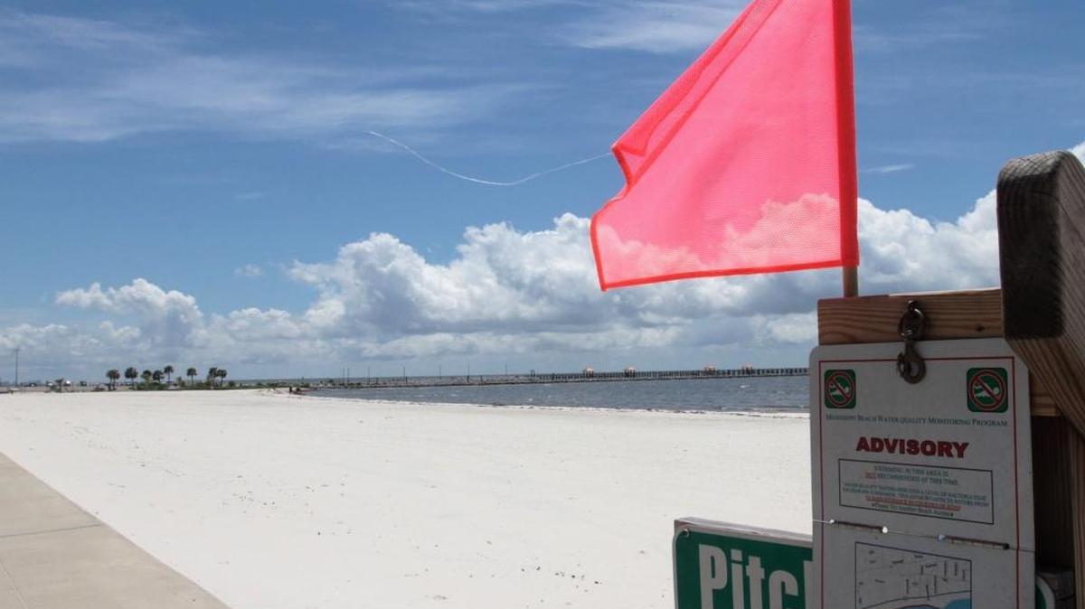 A swimming advisory sign on the beach west of Courthouse Road in Gulfport warns visitors about high bacteria levels in the water. A similar warning was issued in Long Beach on Tuesday.
