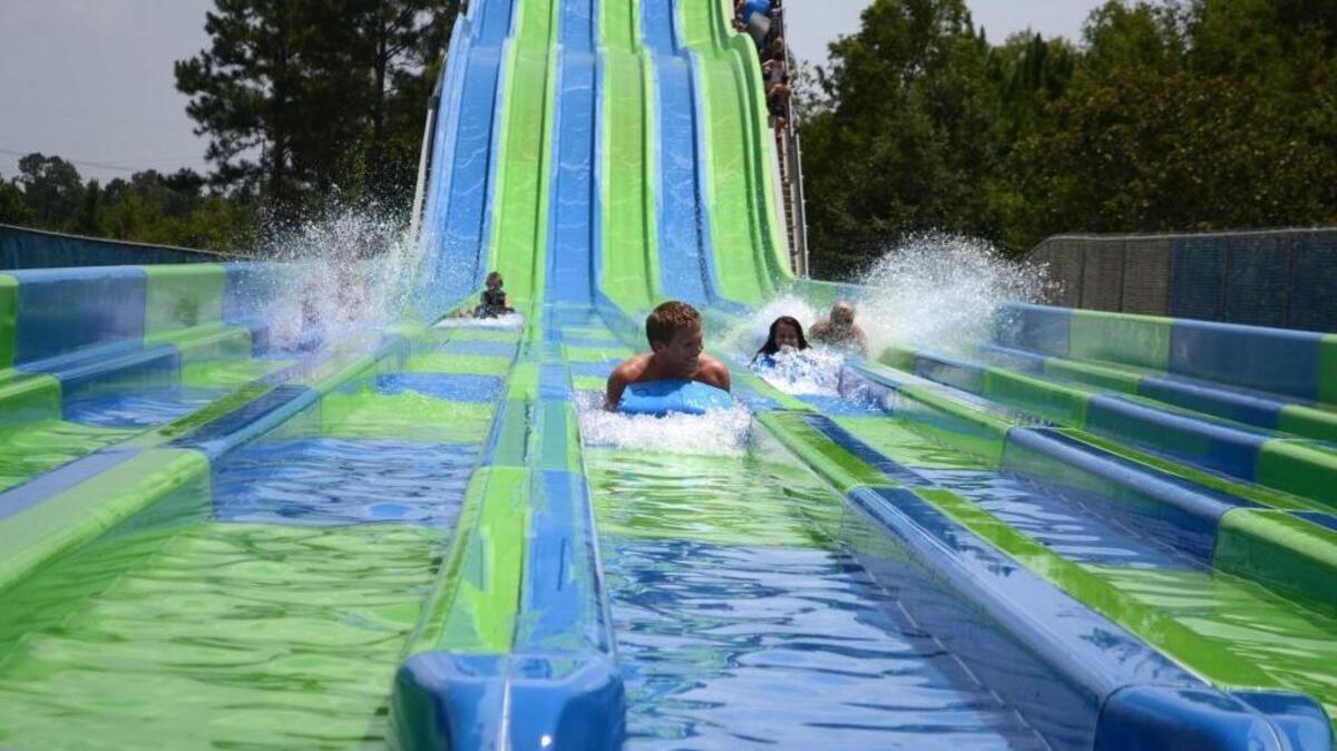 Park-goers race down the Riptide Racer water slide at Gulf Islands Water Park in Gulfport.