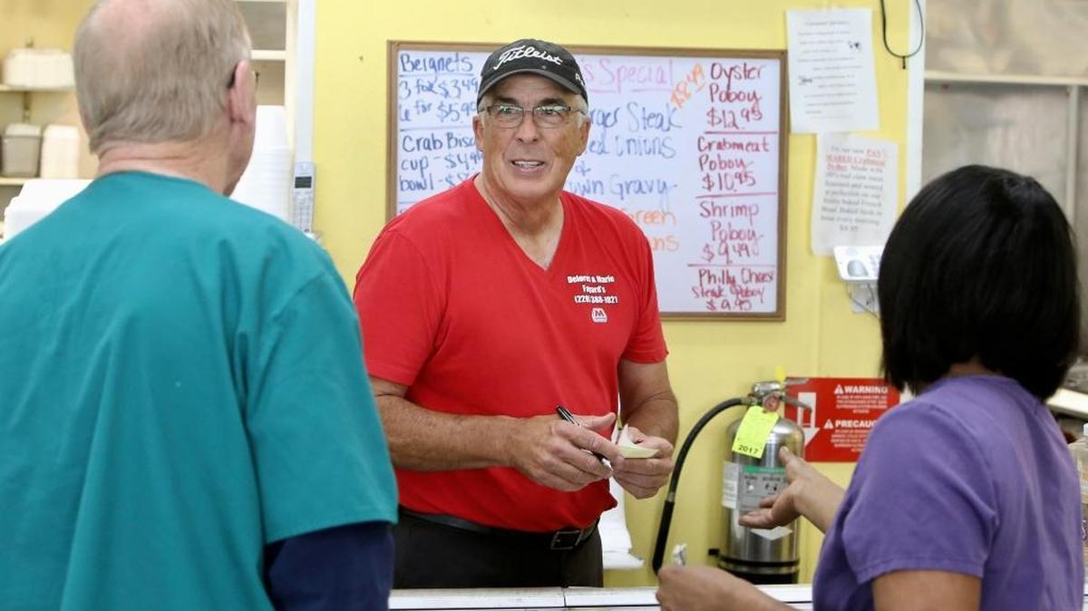 Keith Fayard speaks with customers at Fayard's Poboy shop on Monday. Fayard found a missing Baton Rouge woman in a room of a home he is building and helped get her to safety.