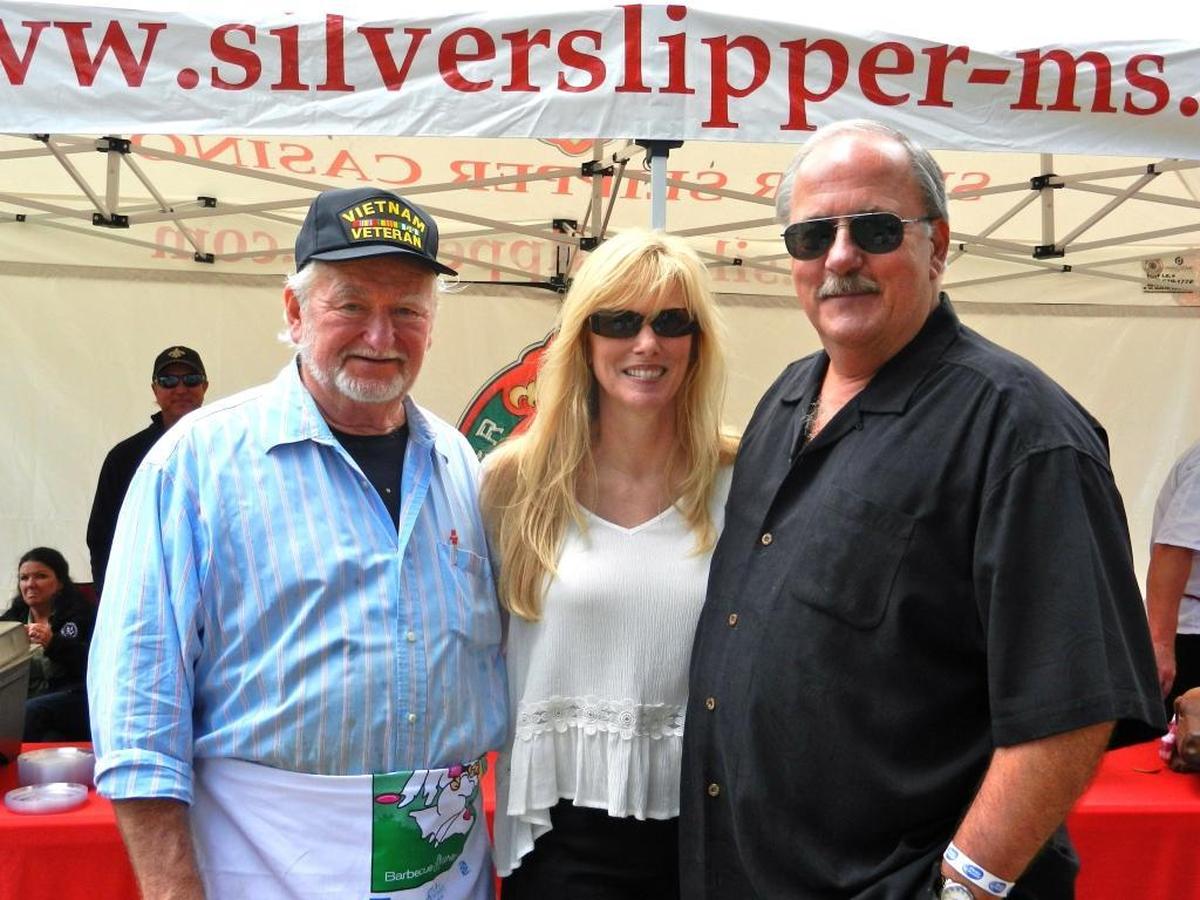 Proudly wearing his Vietnam Veterans hat and his apron, Walter Blessey IV joined the Silver Slipper Casino team at BBQ Under The Oaks in 2014. Joining him are Bridget Ferrucci and John Ferrucci, the general manager of Silver Slipper Casino.