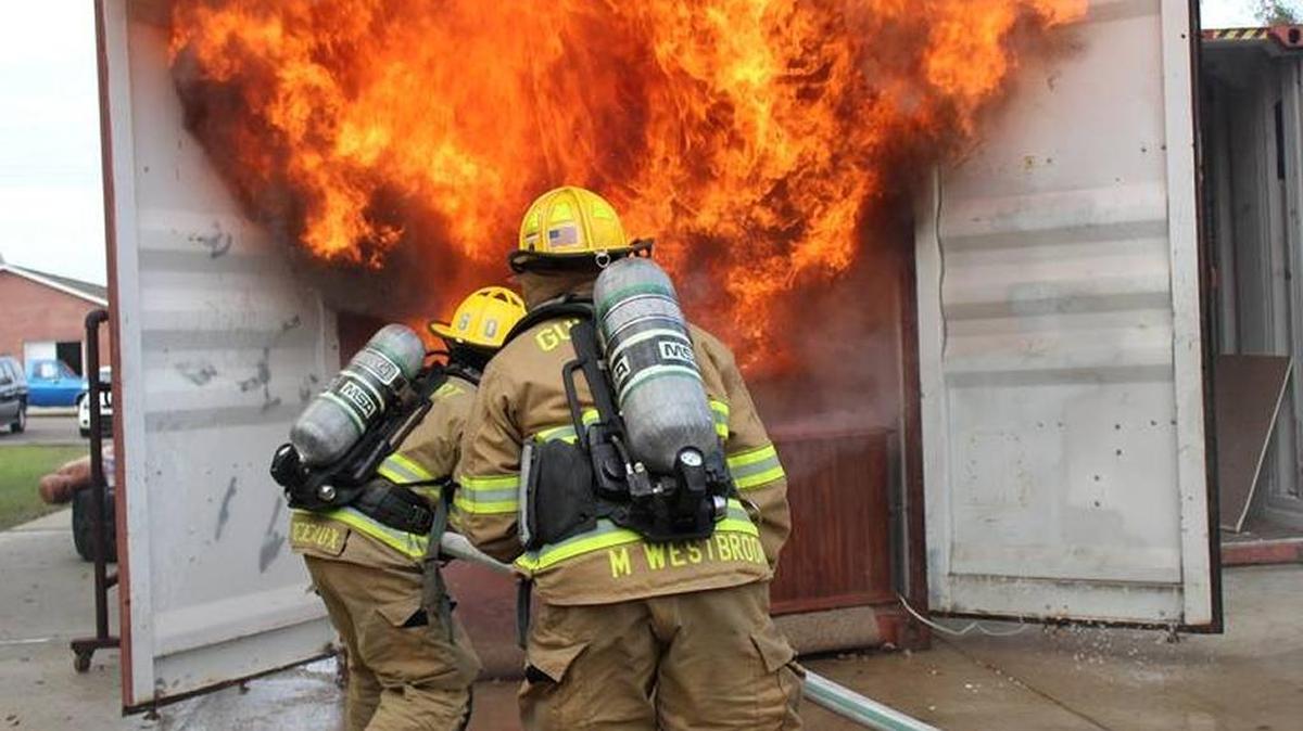 Gulfport firefighters extinguish a controlled blaze during a demonstration on fire safety during the Christmas season.