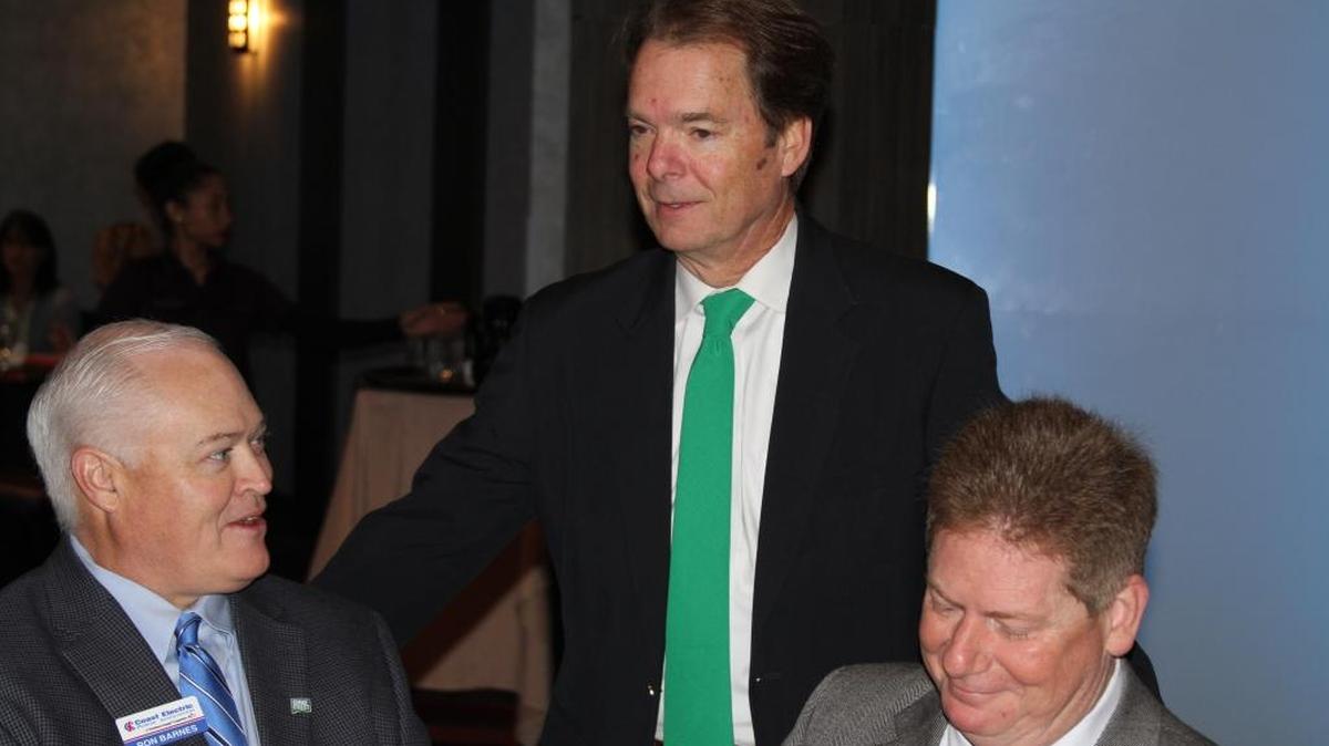Mayor Billy Hewes, center, greets Ron Barnes, left, and Guy Johnson of Coast Electric before delivering his annual address at a breakfast sponsored by the Gulfport Chamber of Commerce at Island View Casino Resort.