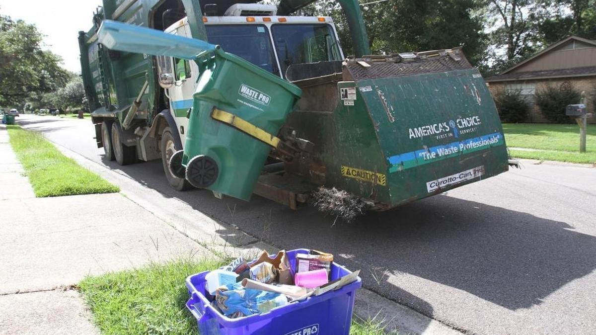 In this file photo, a Waste Pro truck picks up garbage in Gulfport in July 2017. Under a new contract, recycling bins are being replaced with full-sized cans and recyclables will be collected once a week, as opposed to biweekly.