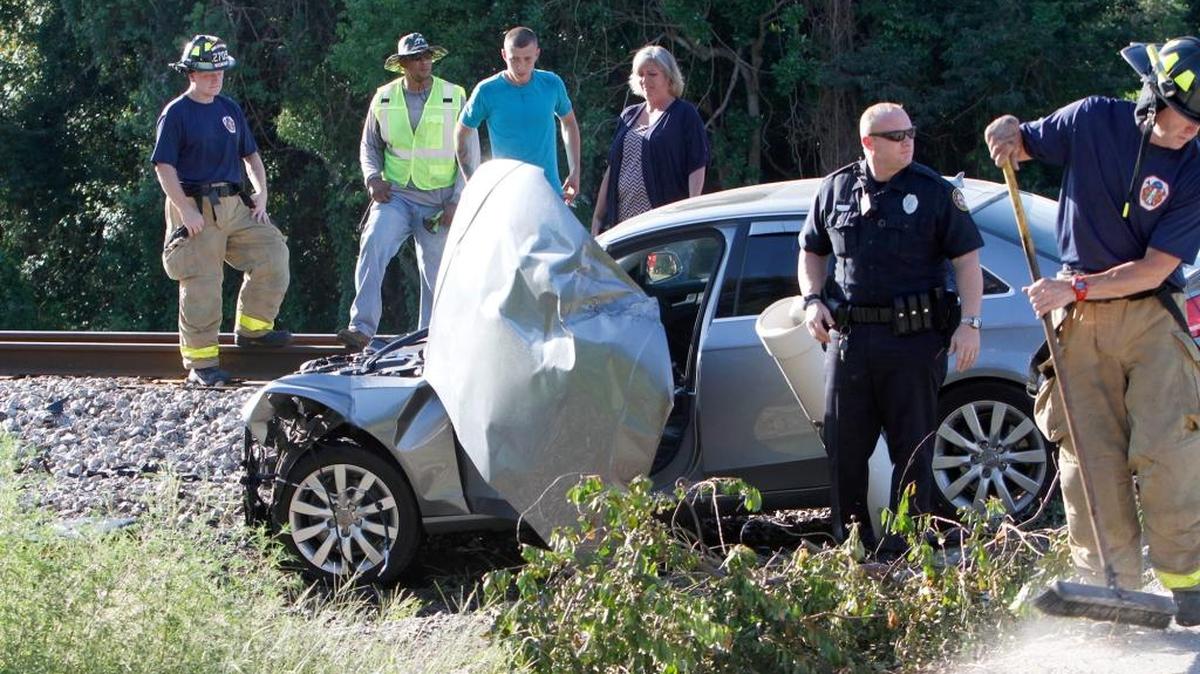 Emergency personnel work the scene of a car-train accident on Seal Avenue in Biloxi on Thursday afternoon.