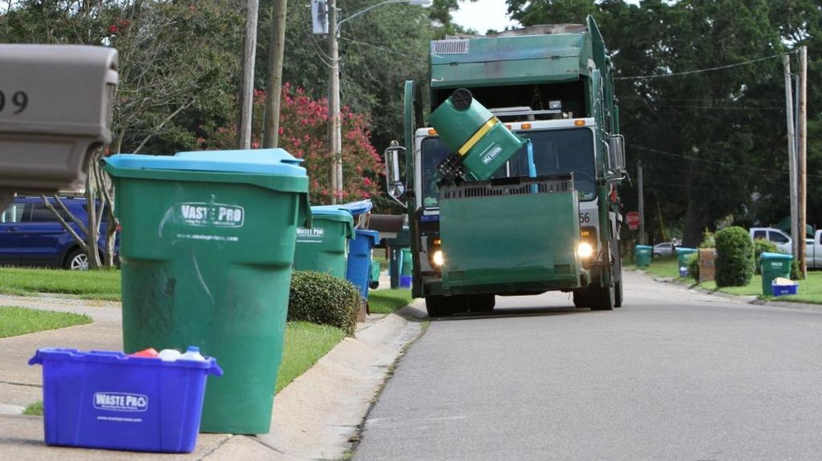 A Waste Pro truck picks up garbage in Gulfport with a side-arm truck. Gulfport said those trucks leak hydraulic fluid and scattered garbage across town.