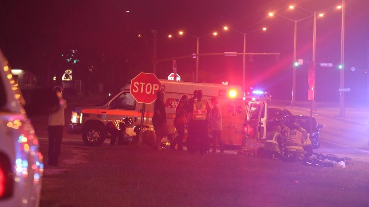 Biloxi fire officials and American Medical Response crews assist a person involved in a three-vehicle wreck on U.S. 90 in Biloxi on Tuesday night.