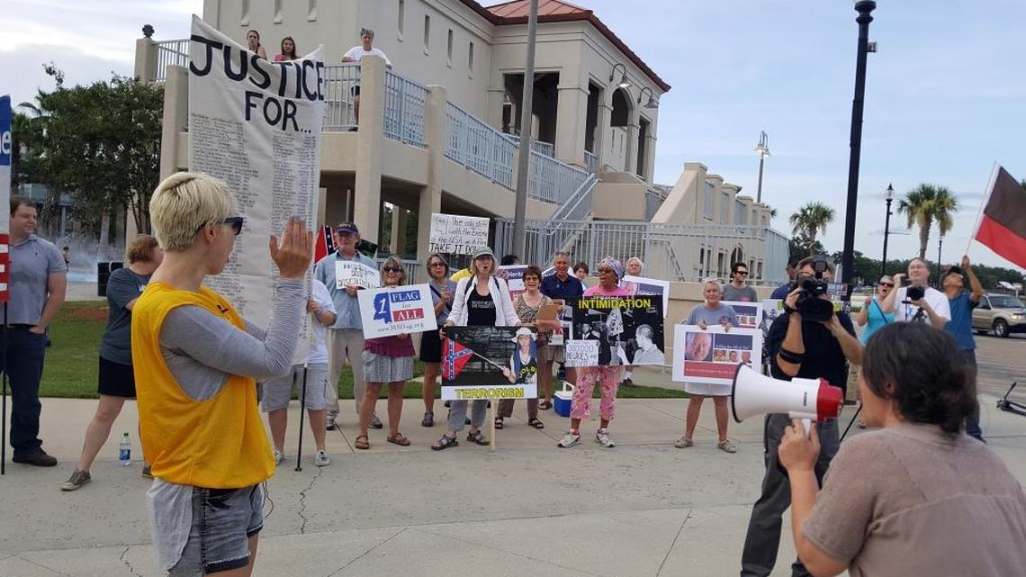 Lea Campbell, left, of Mississippi Rising Coalition leads in protest chants at Jones Park in Gulfport. The chants were directed at the Southern Legislative Conference reception across the street on Saturday, July 29, 2017.