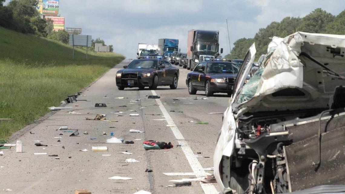 Mississippi Highway Patrol cars block Interstate 10 traffic near County Farm Road on Saturday after a pest-control truck left the road and flipped several times.