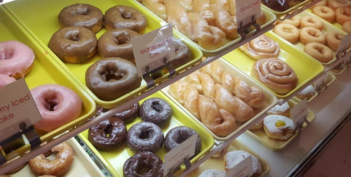 The popular Persian, a round cinnamon roll, is to the left of center in the display case at TatoNut.