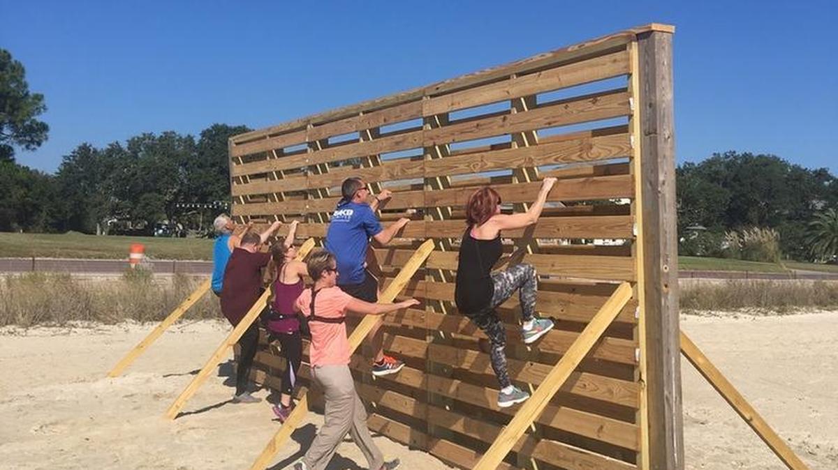 A crew of runners — Jimmy Krebs, left, Justin Mitchell, Kristi Ducote, Richard Davis, Darcie Crew and Karen Strickland — tests the obstacle course recently for safety.