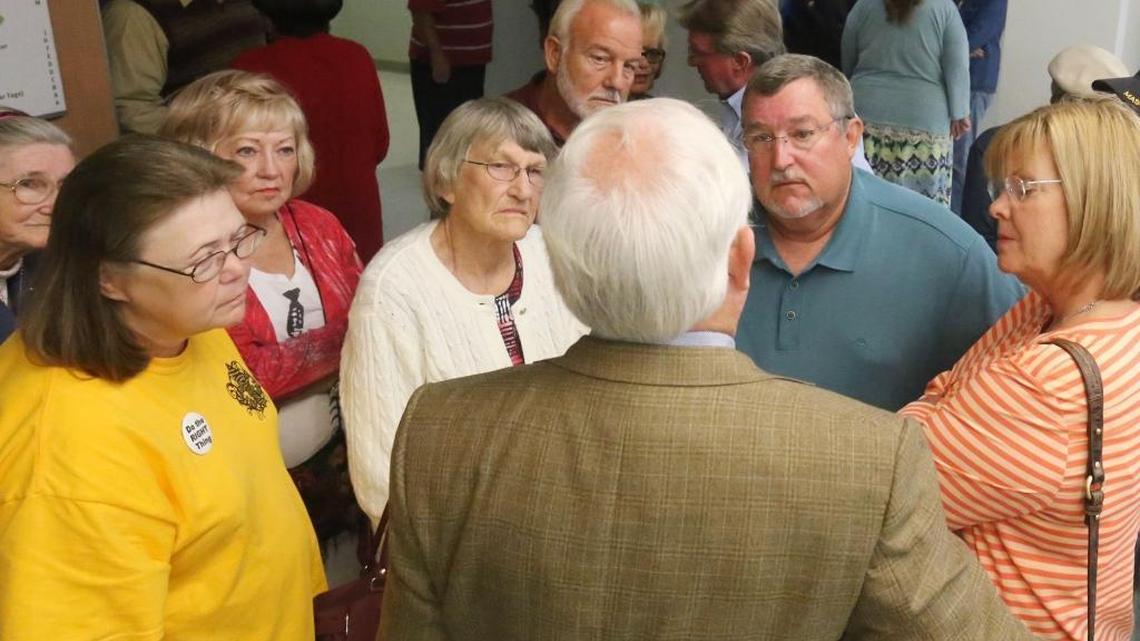 Attorney Harvey Barton, whose back is to the camera, talks to Singing River Health System retirees outside an Octobert 2015 meeting of the Jackson County Board of Supervisors. Barton and attorney Earl Denham are representing their clients in an appeal of a federal court judge’s decision to approve a settlement over their failed pension plan.