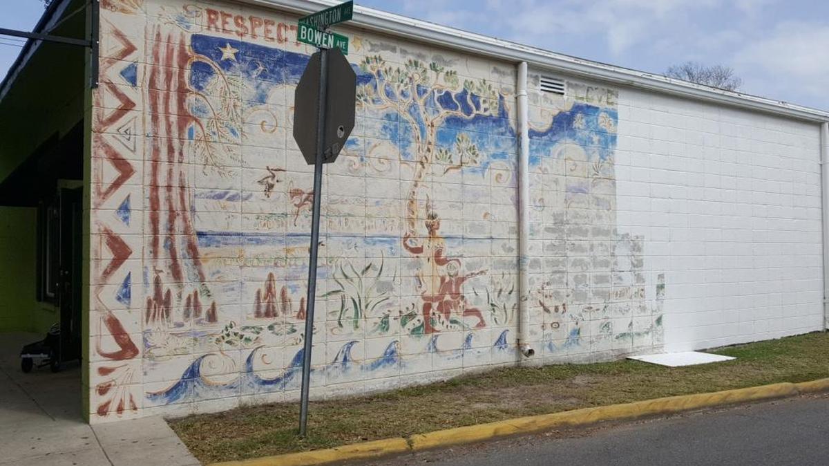 A mural painted by artist Chris Stebly was being painted over on Tuesday, March 7, 2017. The mural was painted on the south side of the building at the corner of Washington Avenue and Bowen Avenue in Ocean Springs.