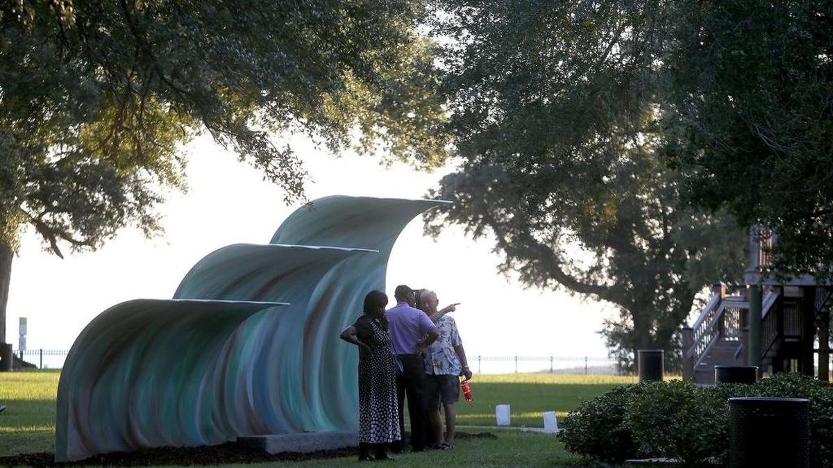 A vote Tuesday could set a 2 percent restaurant tax to support recreation and parks. Here, a group gathers around the public art installation of three waves at Beach Park in Pascagoula in 2015.