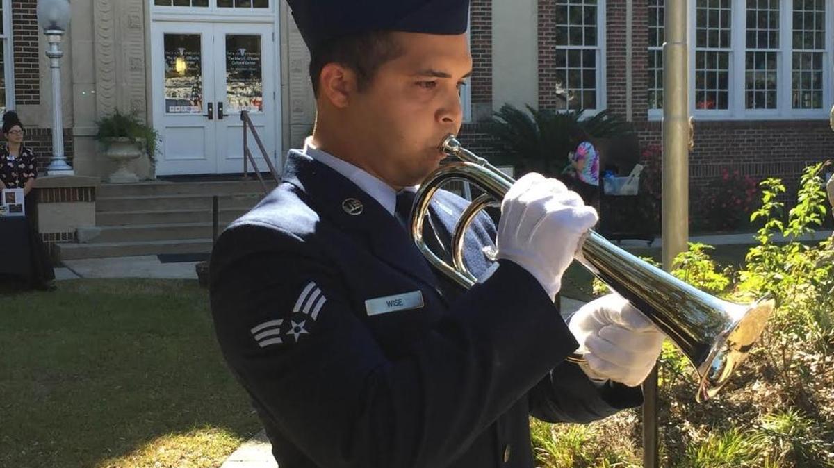 Air Force Senior Airman James Wise blows taps during a ceremony at Pershing Square on the lawn of the Mary C. O’Keefe Cultural Center on Saturday the end point of Ocean Springs’ first Veterans Day parade since 1927.