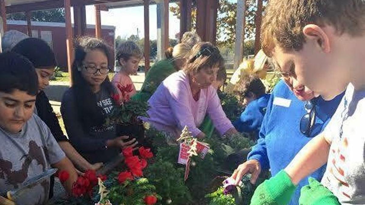 Students with the Ocean Springs Upper Elementary participate in hands-on learning with a garden that they tend. Checking the pH balance is part of the experience.