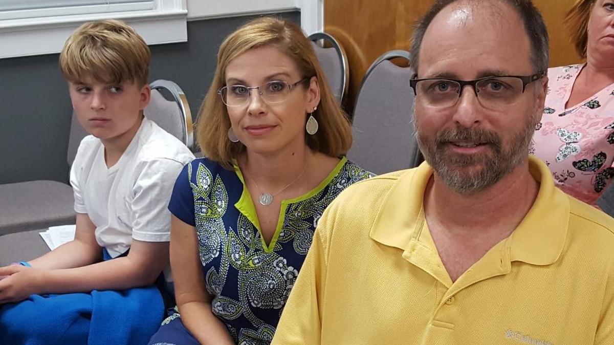 The Boudreauxs, from right, Dale and Daralyn, with their son Evan, attend the Ocean Springs aldermen’s meeting to plead their case to keep their basketball goal. It isn’t ugly or unsafe, Dale anda Daralyn said.