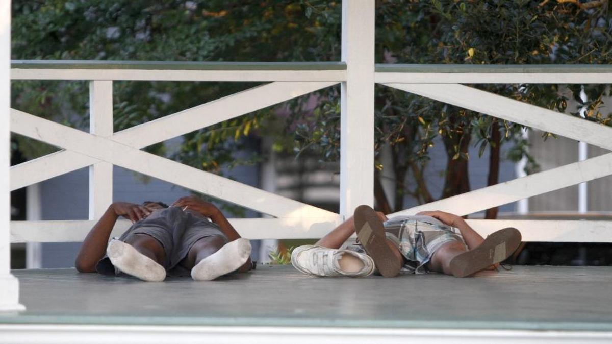 Two homeless men sleep in the gazebo at Marshall Park in June 2016. The city is considering a new program to help put the homeless to work.