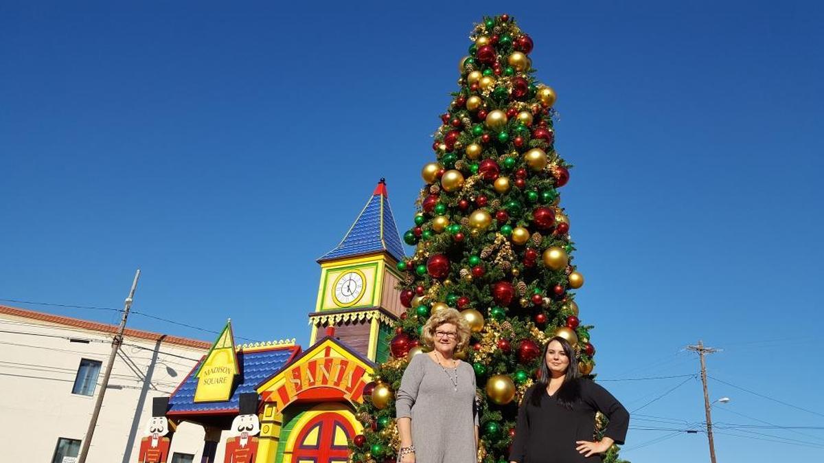 Pascagoula’s Rebecca Davis, left, and Suzanne Kinsey usher in the Friday festivities for downtown with a $20,000 Christmas tree, donated by a local business.