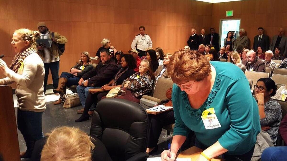 Jacquelyn Bleau, left, talks to Jackson County supervisors as Nora Richburg signs up to speak.