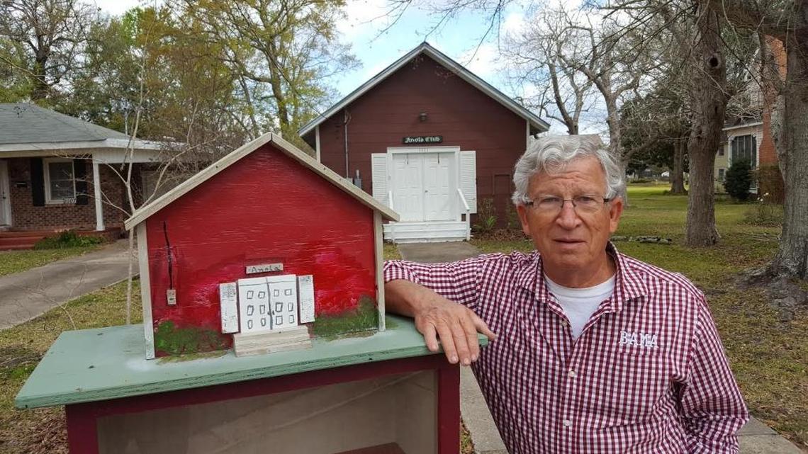 Bud Ehlert show a replica he built of the Anola Club, a long-established Pascagoula women’s club, rest atop a Little Free Library on the clubhouse property.
