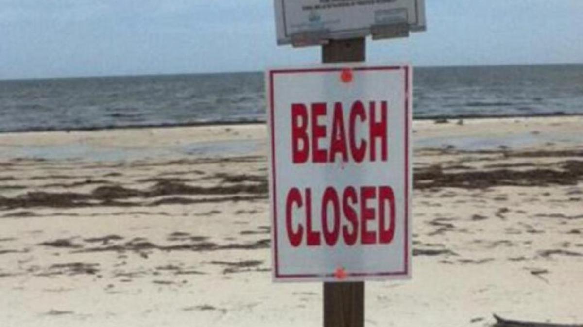 Signs were posed on Front Beach from Jackson Avenue east to the Small Craft Harbor in Ocean Springs after a sewage leak dumped wastewater on Tuesday.
